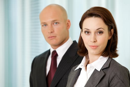 Portrait of young caucasian businessman and businesswoman in office