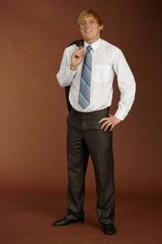 Young man standing on a brown background