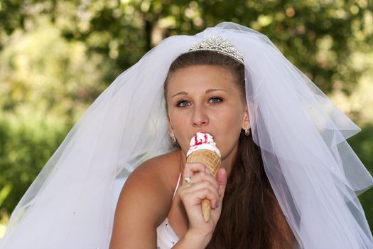 Bride eating ice cream on a green background