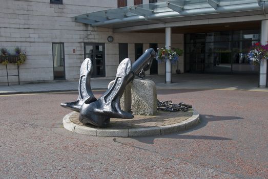 A Large Ships Anchor outside a building