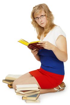 A young girl - a student reads a books