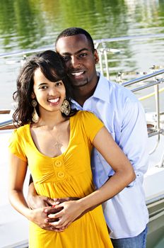 Young romantic couple hugging and standing at harbor