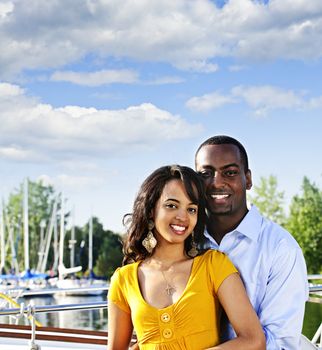 Portrait of young romantic couple standing at harbor with copyspace