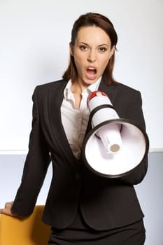 Portrait of businesswoman shouting through megaphone