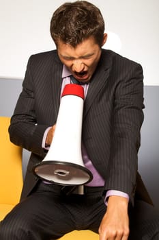 Businessman shouting through megaphone