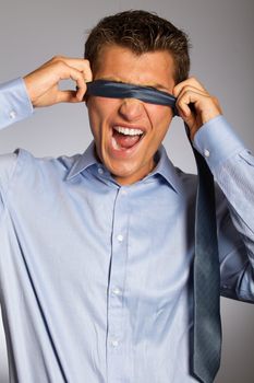 Blindfolded businessman making face