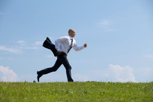 Businessman running in park