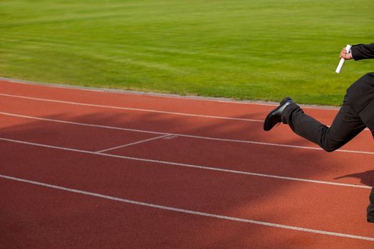 Businessman running on race track