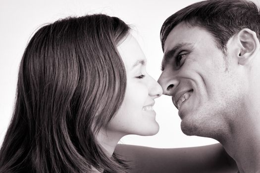 Young adult couple in the studio kissing