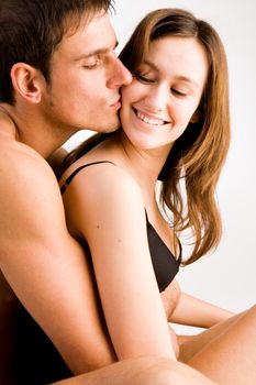 Young adult couple in the studio hugging