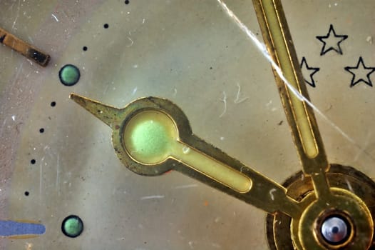 Close-up of an old and cracked clock's hands