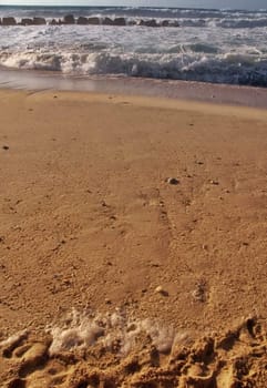 Beach and rough sea in the distance