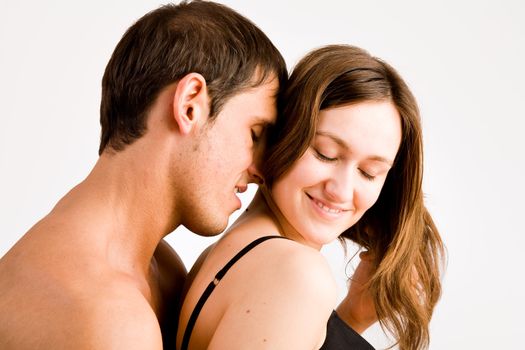 Young adult couple in the studio hugging