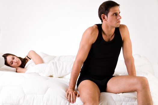 Young adult couple in the studio on a bed