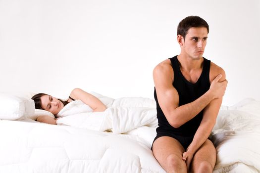 Young adult couple in the studio on a bed