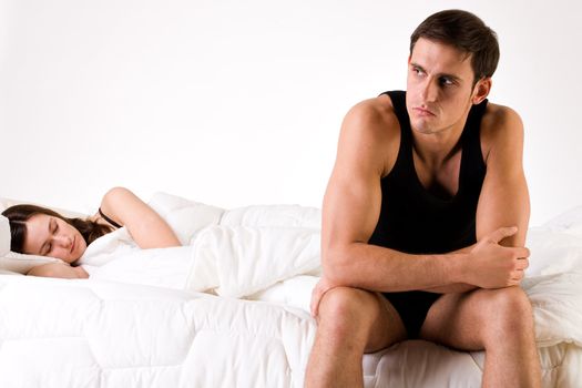 Young adult couple in the studio on a bed