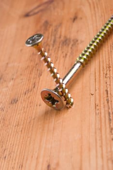 Screw on a wooden background