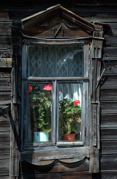 Window of the old rural house with room colors and a curtain