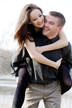 Young man lifting up his beautiful girlfriend