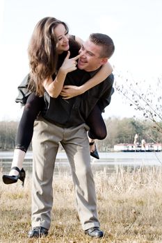 Young man lifting up his beautiful girlfriend