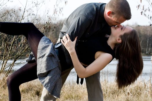 Young loving couple are hugging in the park