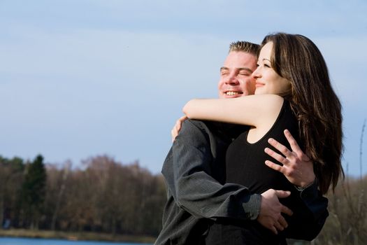 Young couple enjoying the sunlight in the park