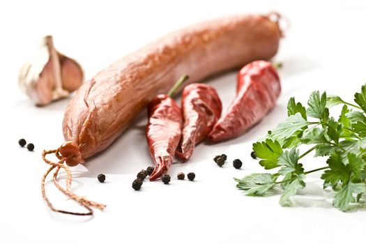 Appetizing smoked sausage with pepper and parsley