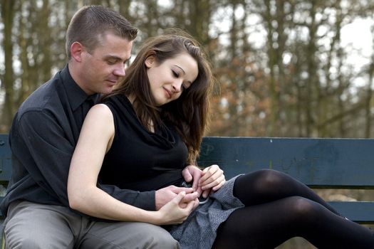 Man and girlfriend on a bench in a park with a depression