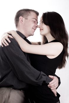 Studio shot of young loving couple caring