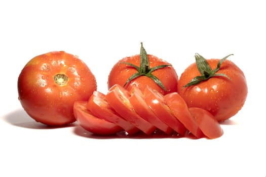 close view detail of a bunch of red tomatoes isolated on a white background.