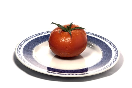 close view detail of a red tomatoe on a plate isolated on a white background.