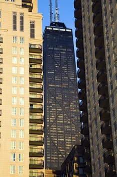 Hancock Tower squized between skyscrapers in downtown Chicago, IL.