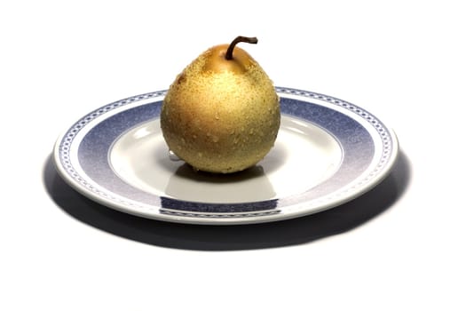 close view detail of a  pear on a plate isolated on a white background.