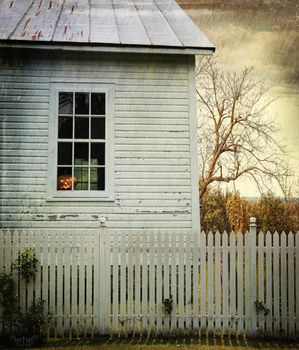 Old farm  house window with pumpkin for Halloween