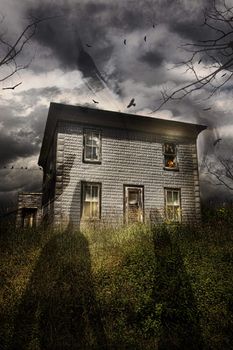 Old abandoned house with flying ghosts for Halloween