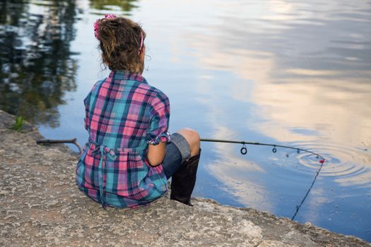 Fishing time - little girl by the lake.