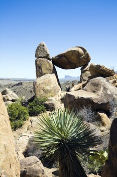 Tourist sitting under Balanced Rock in Big Bend National Park.