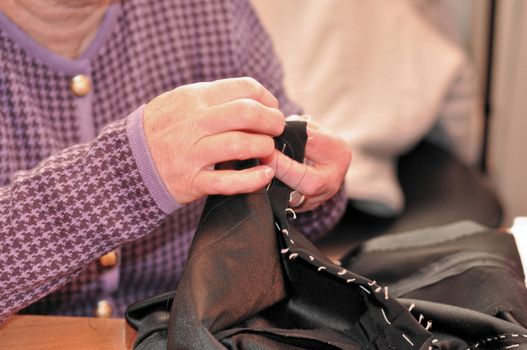 A sewing professional tailor at work making cloth
