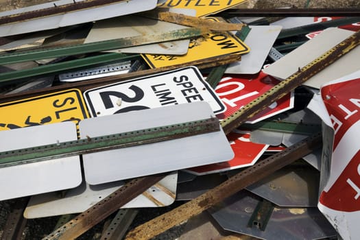 Old road signs on scrap yard.