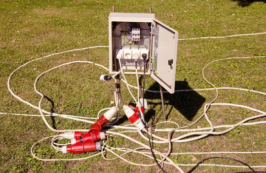 Electrical cutout and many electrical wires extensions connected from rosettes.