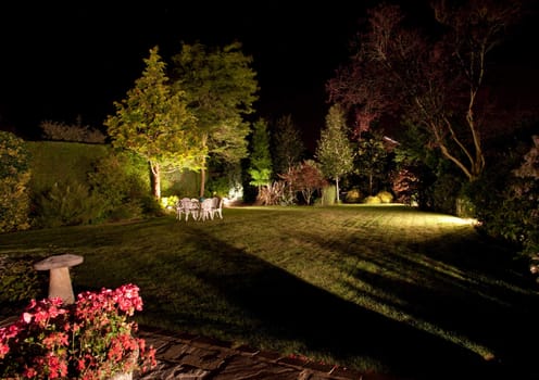 Well tended garden and flowers floodlit at night