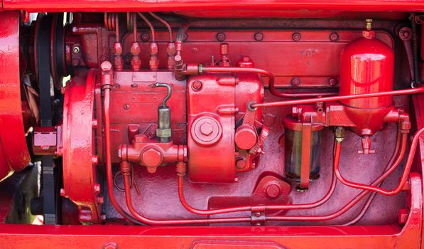 Old vintage tractor engine with solid red engineering