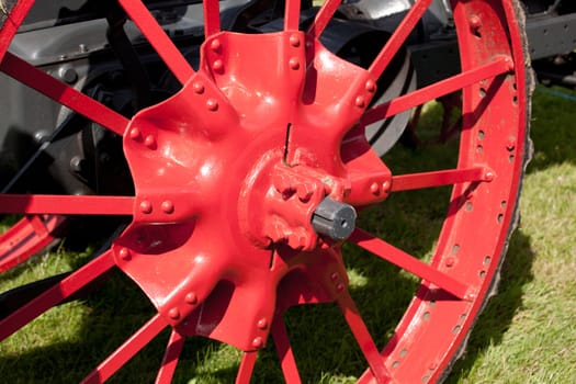 Red painted iron spokes on tractor wheel