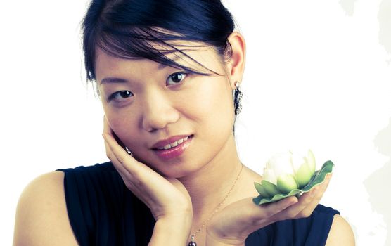 Asian woman holding and smelling beautiful white  lily flower with spa concept isolated