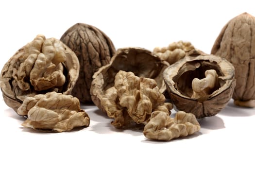 close view detail of  some walnuts  isolated on a white background.