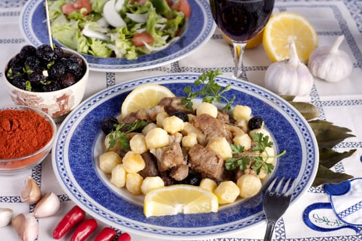 Close up view of a Portuguese meal of cooked meat with potatoes.