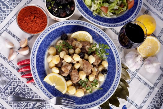 Close up view of a Portuguese meal of cooked meat with potatoes.