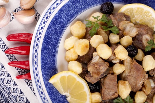 Close up view of a Portuguese meal of cooked meat with potatoes.