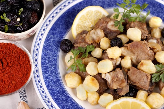 Close up view of a Portuguese meal of cooked meat with potatoes.