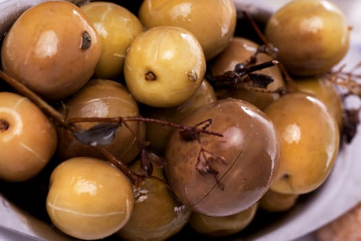 Detail view of a bunch of typical portuguese green olives on a bowl.